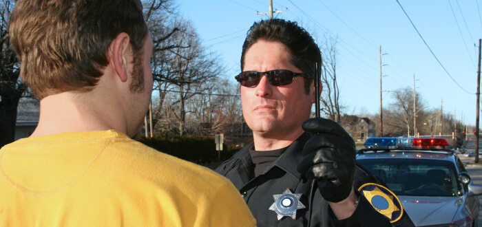 A police officer engages in conversation with a man on the street, fostering community interaction and dialogue