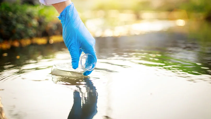 scientist collecting water sample