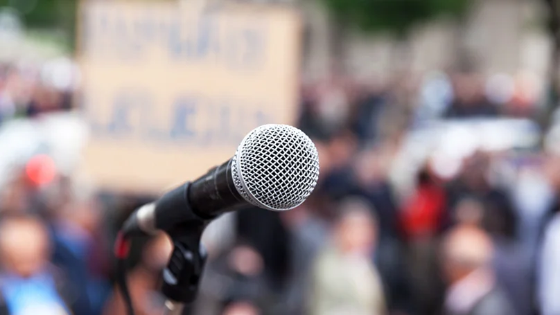 microphone displayed in front of a crowd of people