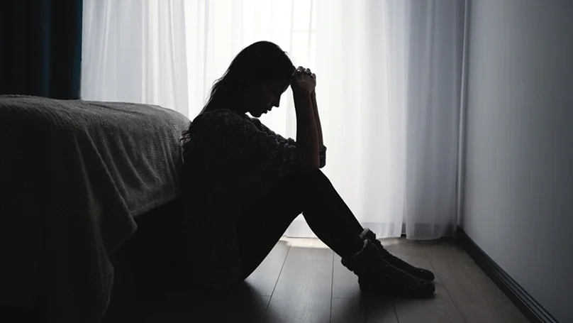 woman sitting in a dark room