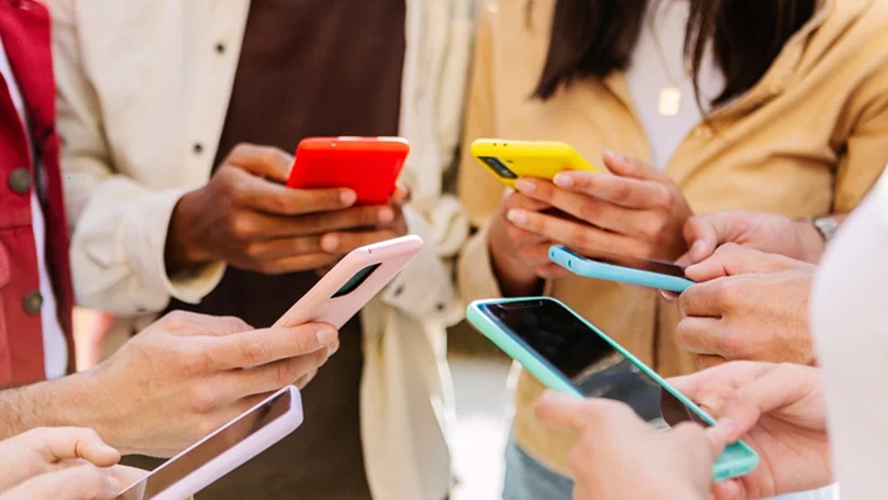 group of teens on their phones