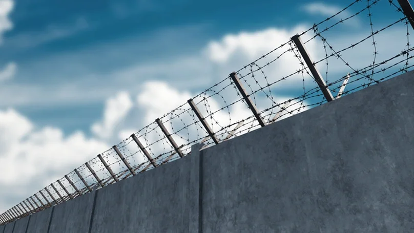 concrete wall with barbed wire