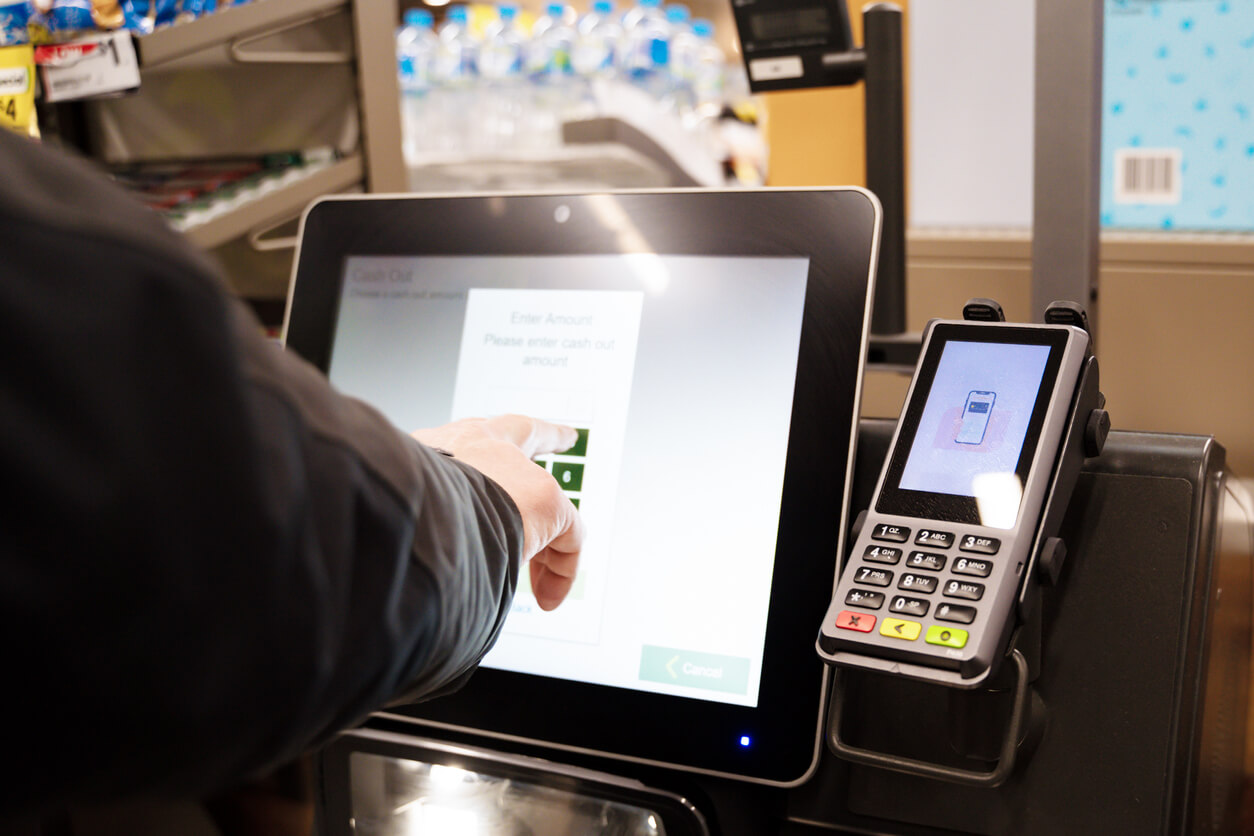 A person at a store using a tablet to complete their checkout process efficiently